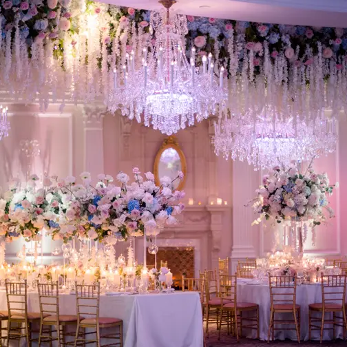 The ballroom at The Rockleigh seen from the dance floor, a ceiling of hanging flowers and crystal above every table.