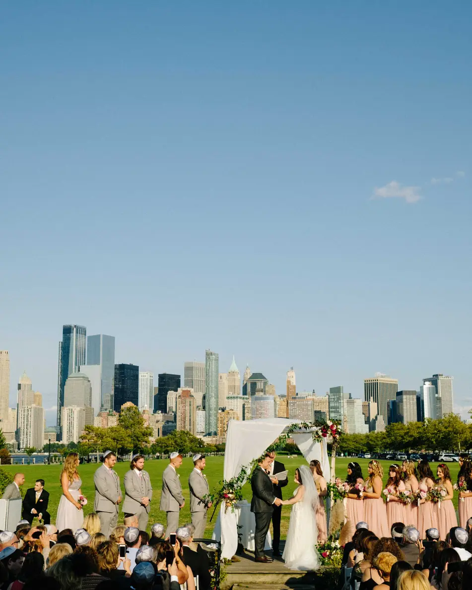 The ceremony on the lawn, the Lower Manhattan skyline across the Hudson.