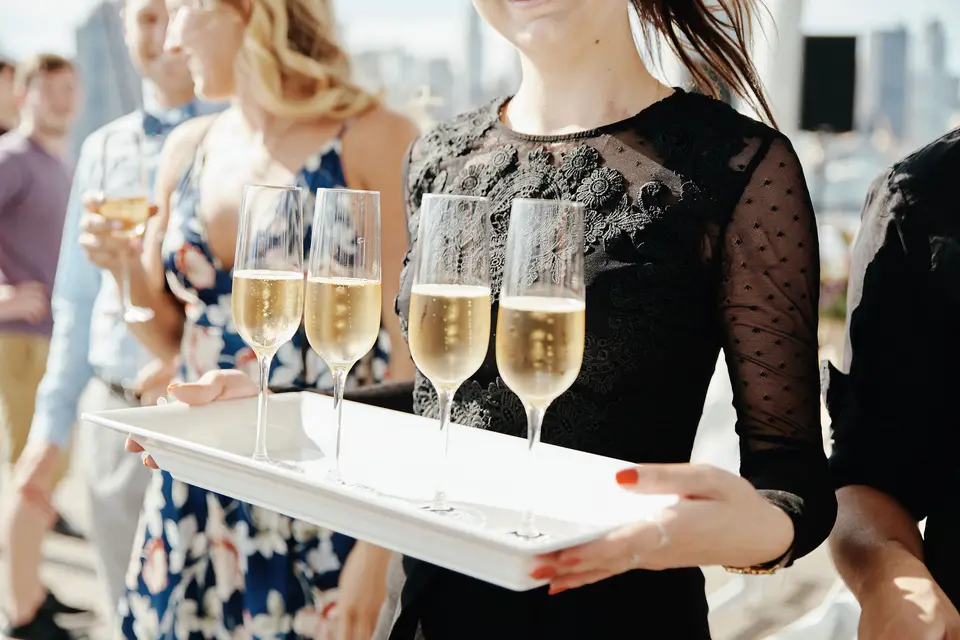A tray of champagne passed among guests on the waterfront.