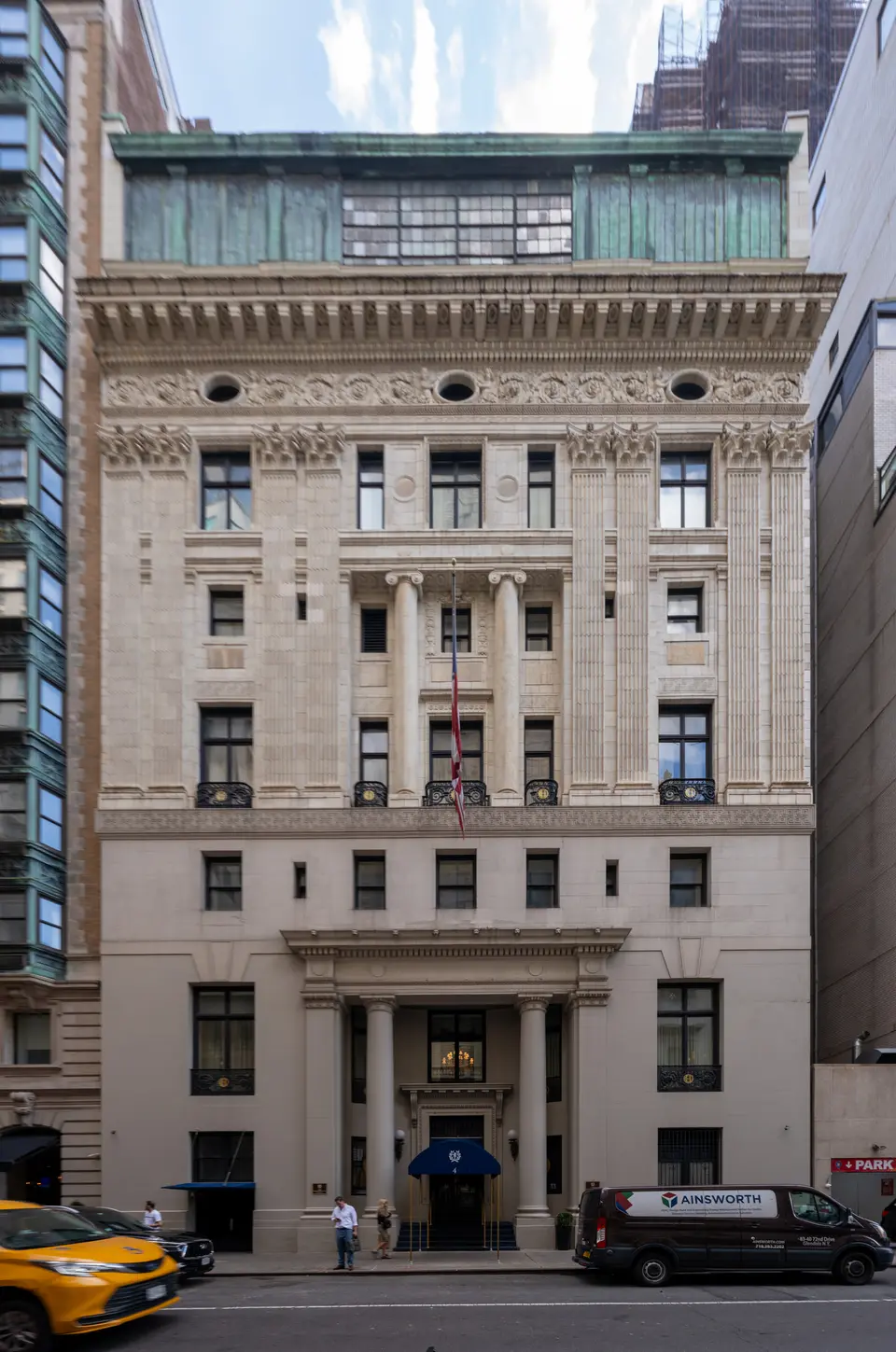 The limestone and brick façade of the Harmonie Club at 4 East 60th Street, its tall arched windows and balconies rising above the street.