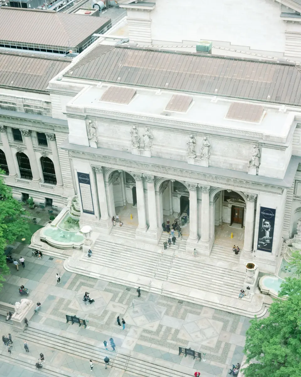 The New York Public Library on Fifth Avenue seen from above, its marble steps and columns.
