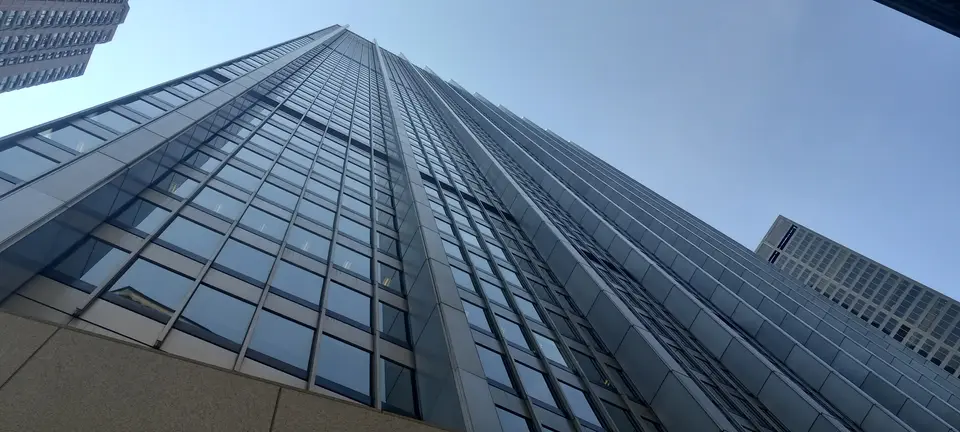 28 Liberty Street, the glass and steel tower in Lower Manhattan whose sixtieth floor holds Manhatta, seen from the plaza below.