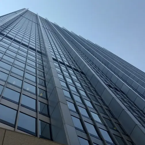 28 Liberty Street, the glass and steel tower in Lower Manhattan whose sixtieth floor holds Manhatta, seen from the plaza below.