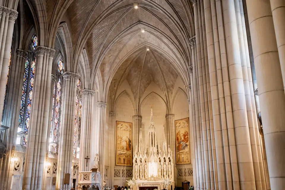 The soaring Gothic nave of the church, stained glass along the aisles.