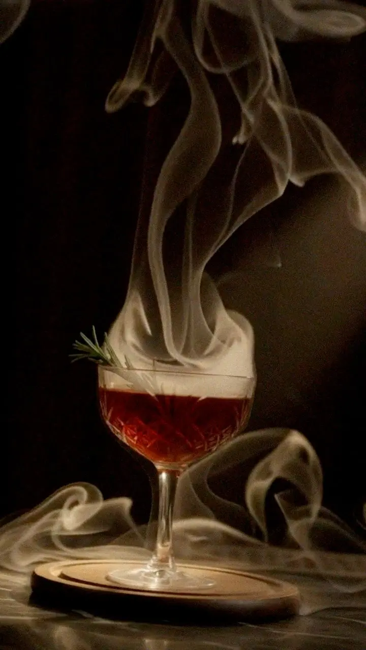 Red velvet curtains and candlelight, a cocktail wreathed in smoke, an empty stage under a single spotlight.