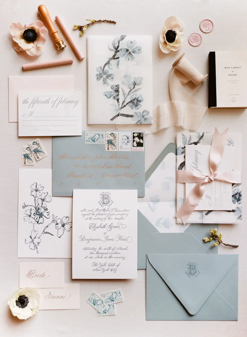 The invitation suite in pale blue and white with botanical drawings, wax seals, ribbon and anemones.