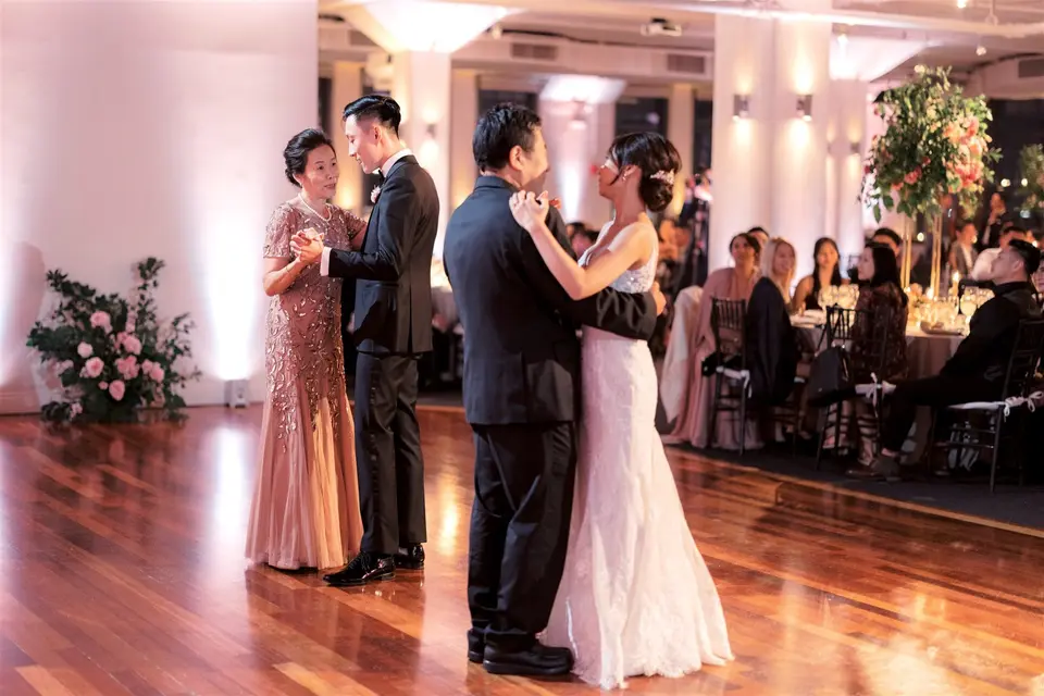 The bride dances with her father and the groom with his mother.