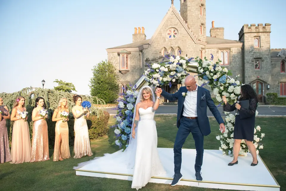 Married, the groom throws up his arm in celebration as they step off the platform.