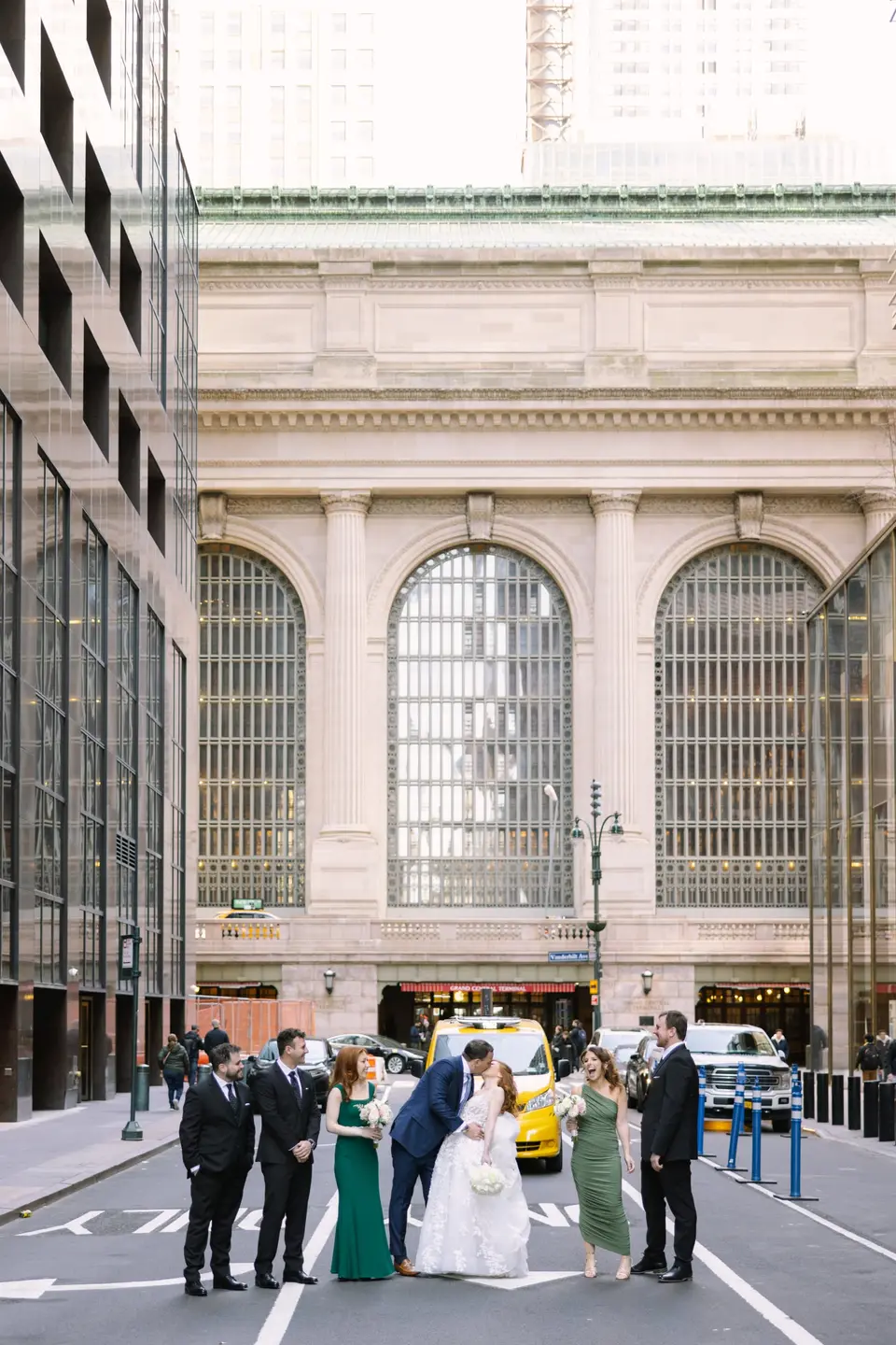 The wedding party on Vanderbilt Avenue, the couple kissing in front of Grand Central Terminal.